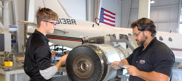 Ryan Sapp and a fellow AMT classmate work on an airplane. 